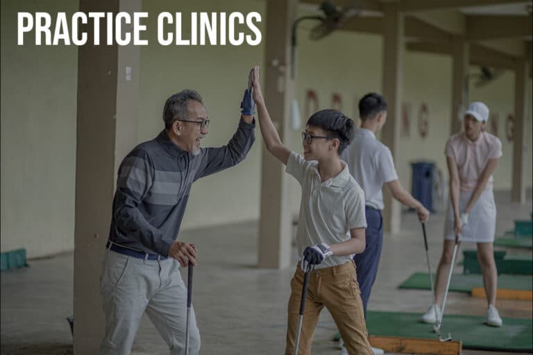 Asian father and son sharing enthusiastic high-five during golf practice clinic, demonstrating joyful learning experience